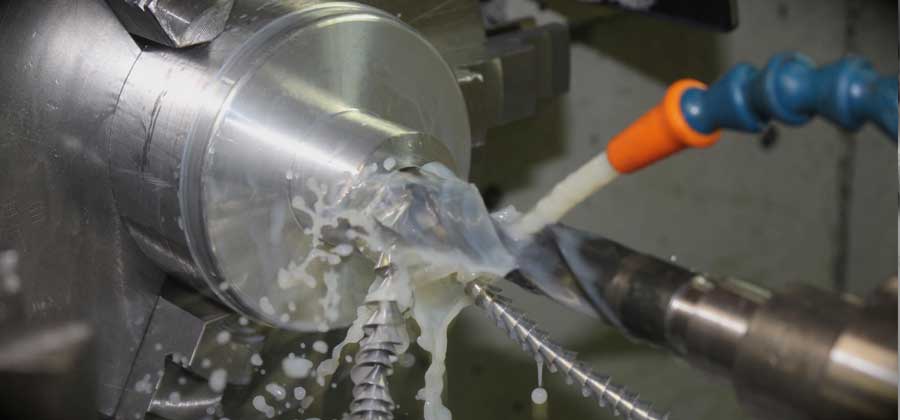 Close up of water being sprayed on to a CNC turning machine