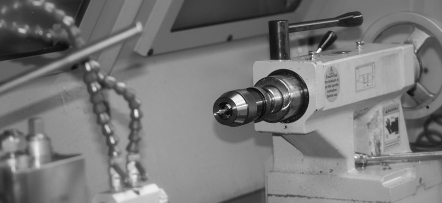 close up of a CNC Turning machine in black and white